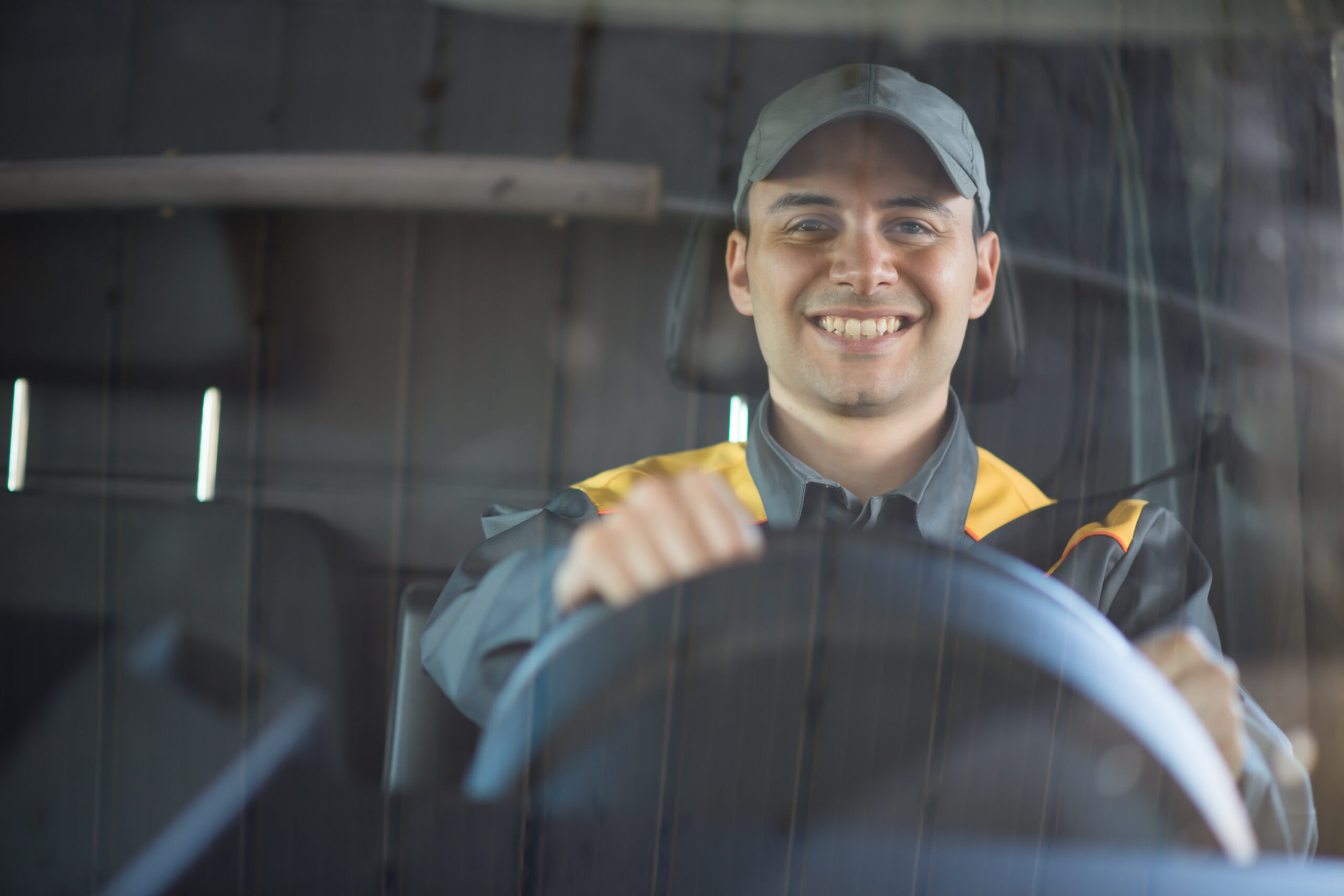 Man holding the van steering wheel and smiling